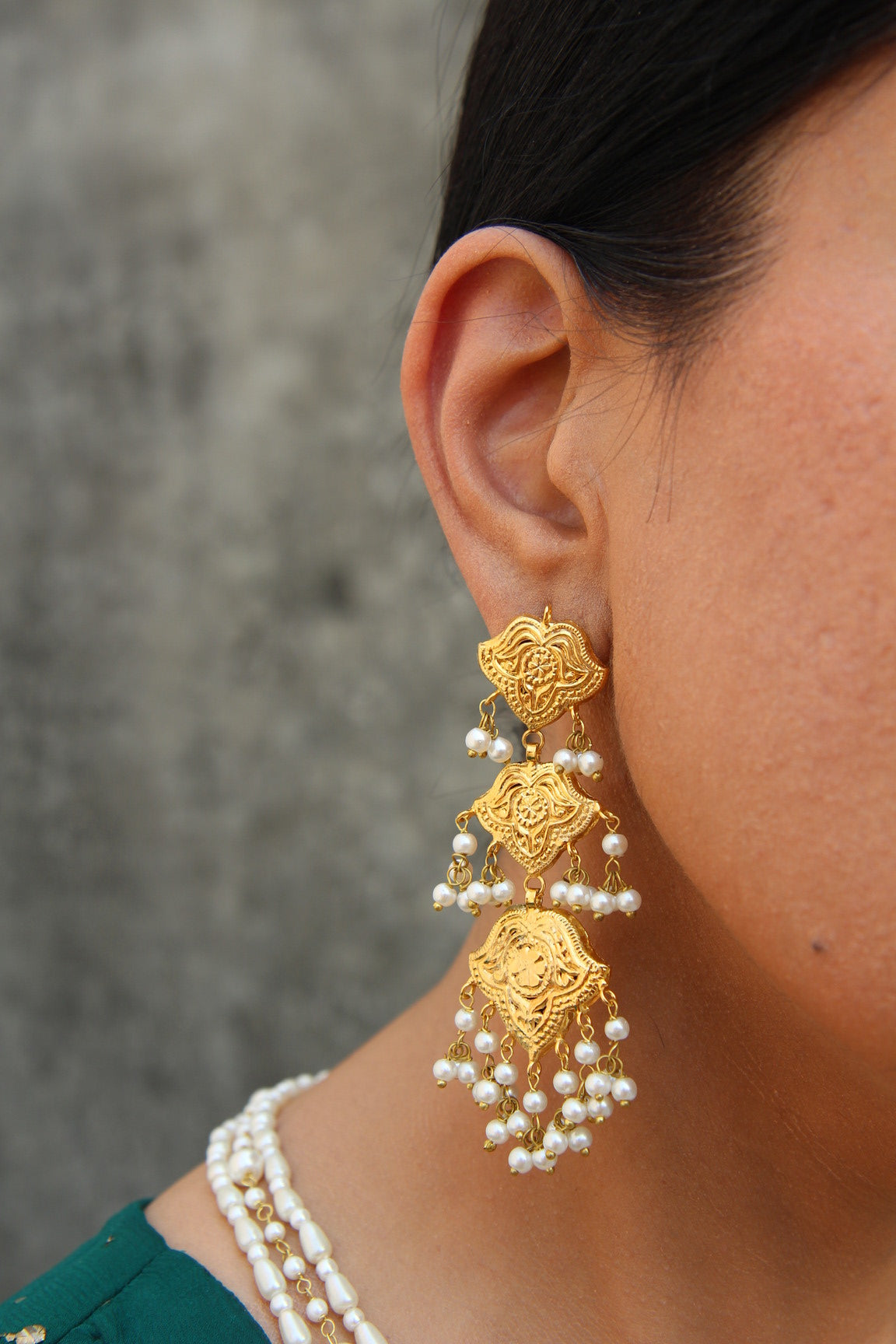 Side view of Shaheena traditional earrings with detailed gold finish