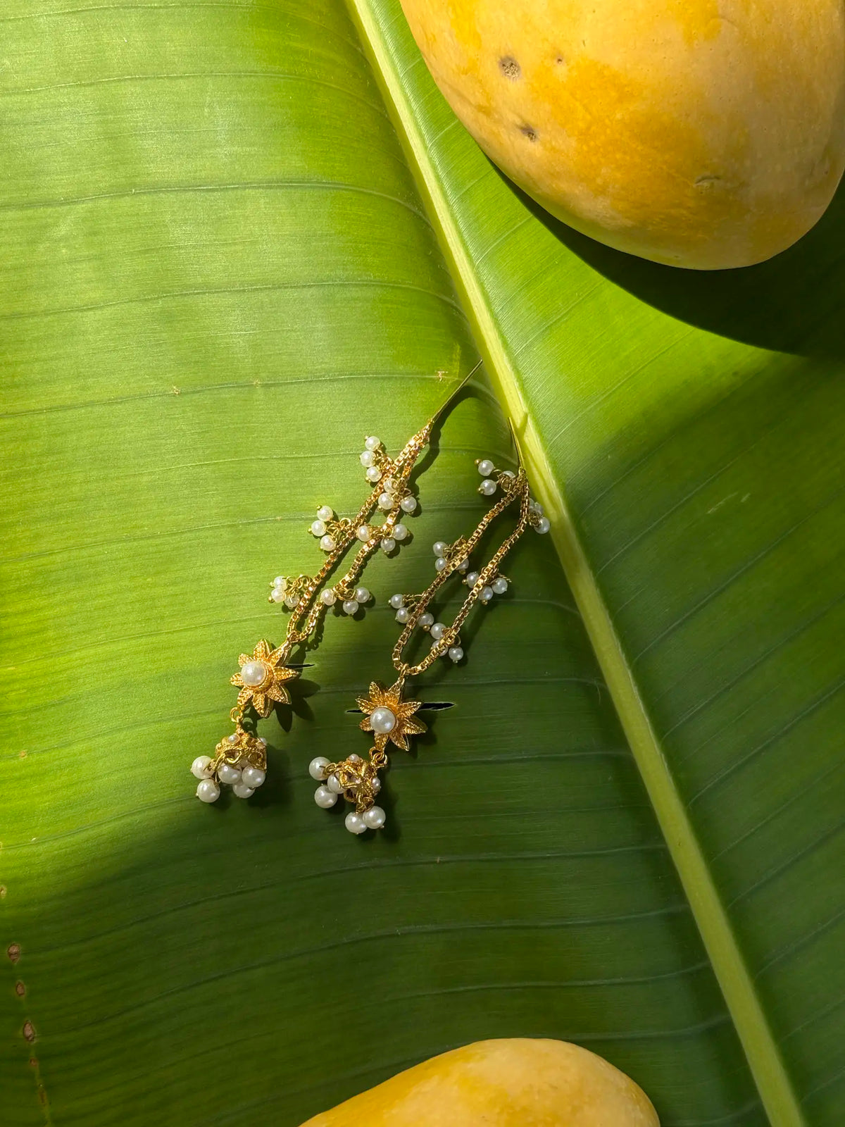 Close-up of Meenu lightweight gold plated pearl earrings with elegant detailing