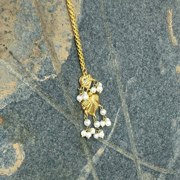 Almas antique gold  tikka with intricate traditional detailing