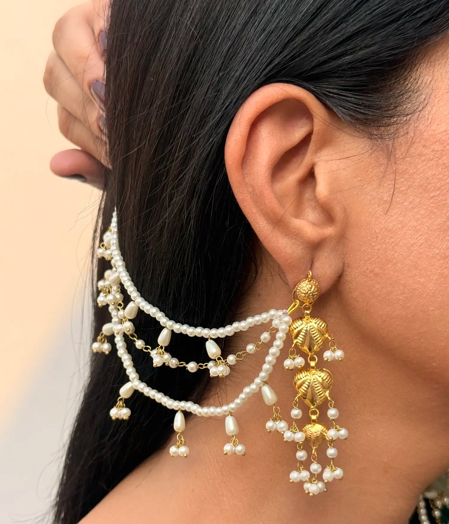 Close-up of Almas pearl saharay earrings showing intricate bridal craftsmanship