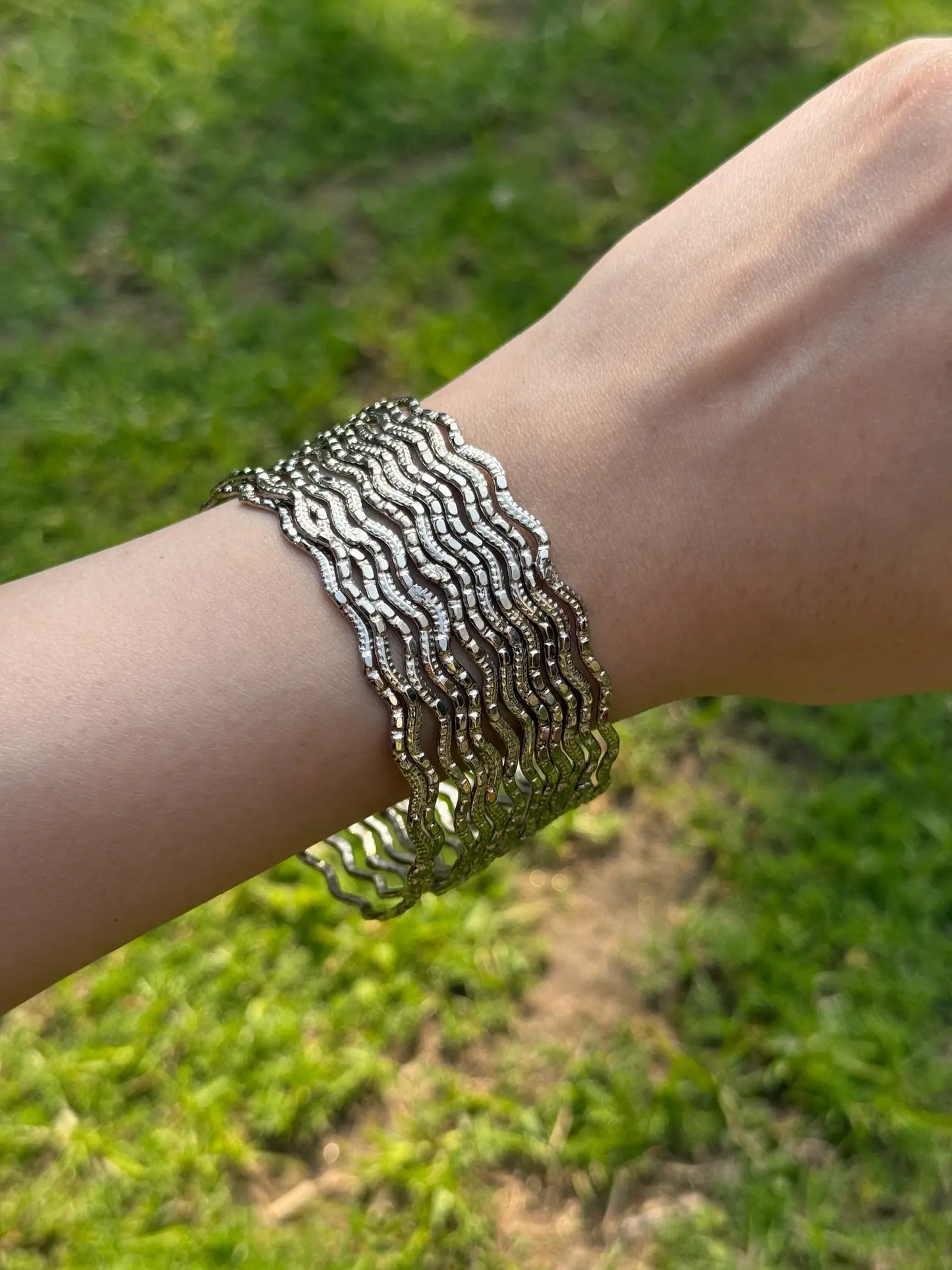 Model wearing silver chamkeeli bangles for Eid, wedding, and party outfits