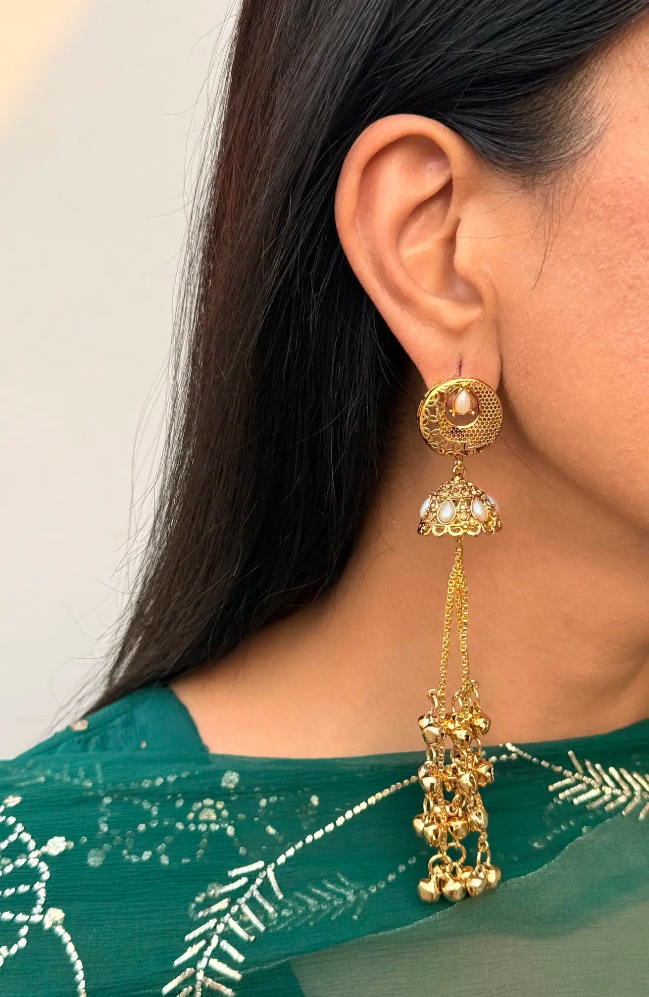 Close-up of pearl Kashmiri jhumka earrings showcasing intricate traditional detailing