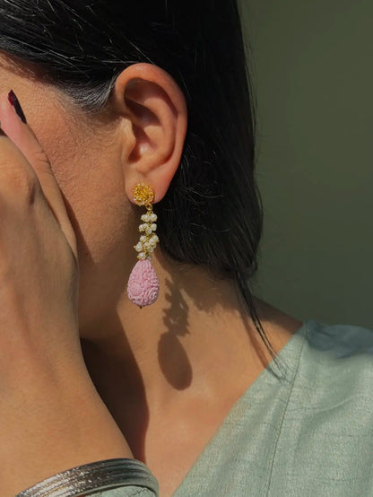 Whimsical powder pink traditional earrings close-up