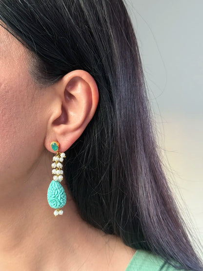 Whimsical turquoise-toned Pakistani earring close-up
