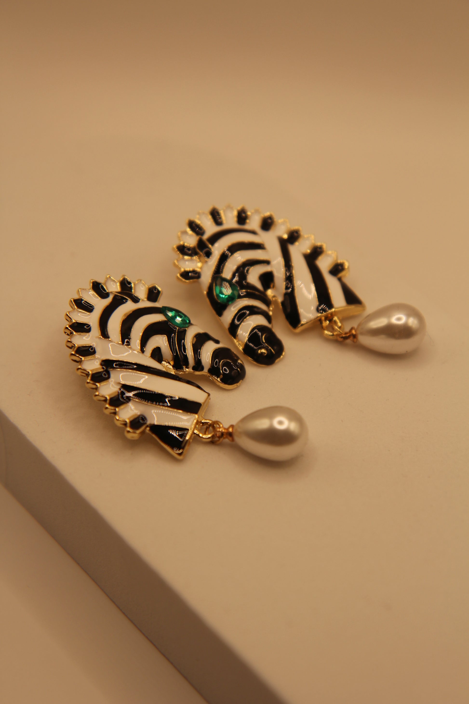 Woman wearing zebra pattern drop earrings with pearl highlights for daily & party wear