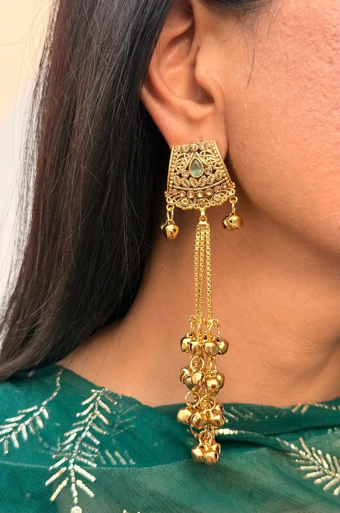 Close-up of mint green Kashmiri jhumka earrings showing intricate ethnic detailing