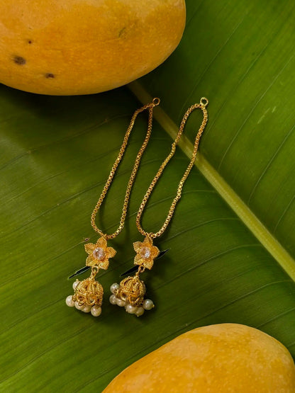 Close-up of Shamsa gold-plated chain earrings featuring delicate chain detailing