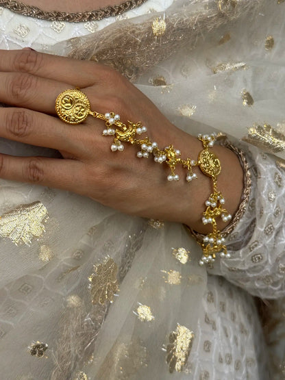 pearl chain detailing and traditional bridal haath phool design